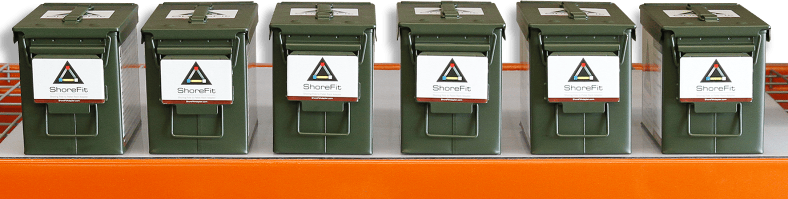 Six green metal ammunition boxes are lined up on an orange shelf, each with a ShoreFit logo on the front. Six green metal ammunition boxes are lined up on an orange shelf, each with a ShoreFit logo on the front.