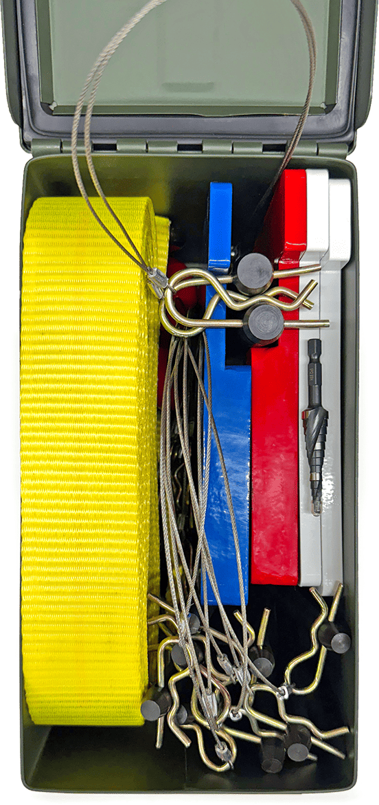 A toolbox containing a yellow strap, metal cables, hooks, colorful plastic blocks, and a drill bit.