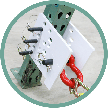 Metal structure with white perforated plates secured by black pins and red shackles on a concrete floor. Metal structure with white perforated plates secured by black pins and red shackles on a concrete floor.